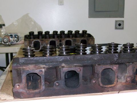 1973 Ford Ranchero - Two engine cylinder heads are shown, one in the foreground, with valve springs visible.