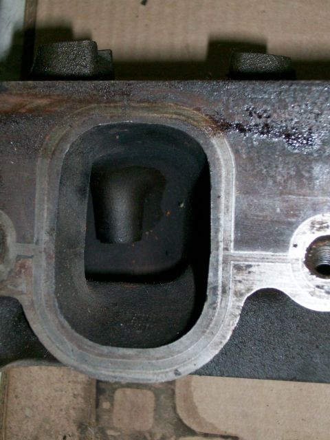 1973 Ford Ranchero - Close-up view of an engine cylinder head port, the Supermotors.net logo at the bottom.