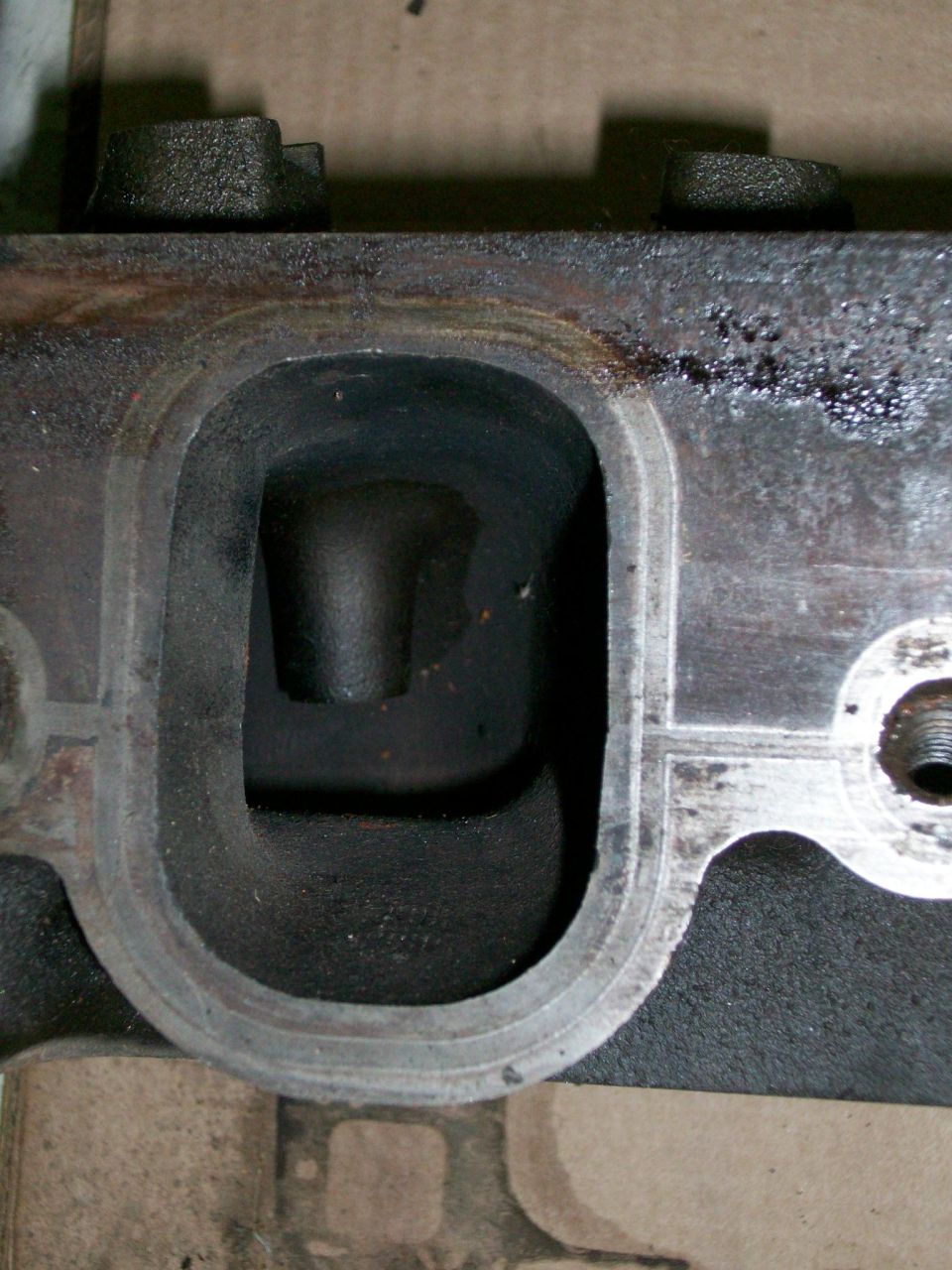 Engine cylinder head port with visible Supermotors.net logo