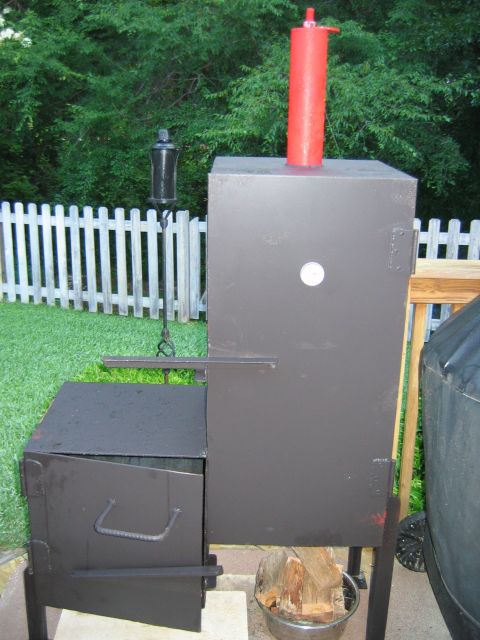 1992 Ford Bronco - This outdoor smoker features a tall red chimney and a dark brown body with a side firebox.