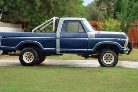 1979 Ford F-150 - This blue 1979 Ford F-150 pickup features a silver cab roof and a chrome roll bar in the bed.