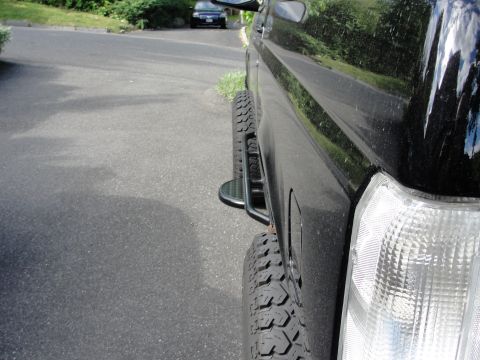 1995 Ford Bronco - Side view of a 1995 Ford Bronco showing its aftermarket side step and aggressive tire tread.