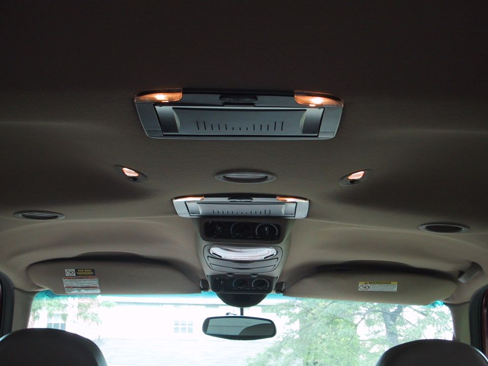 Tan SUV overhead consoles with dome lights and rearview mirror