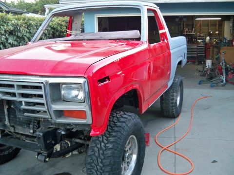 1985 Ford Bronco - This Ford Bronco is undergoing restoration, with parts of the body in primer and red paint.