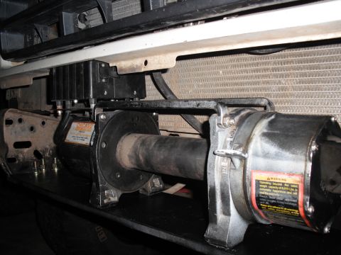 1991 Ford Bronco - A winch is installed on the front of a vehicle, with operational labels clearly visible.
