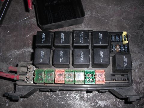 1991 Ford Bronco - Close-up of an automotive fuse box containing several relays and fuses, with visible part numbers.