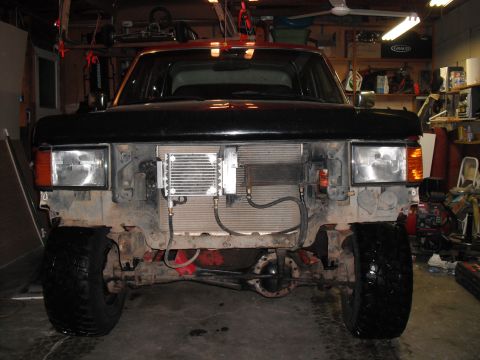 1991 Ford Bronco - Truck front end disassembled, revealing the radiator and an added oil cooler.