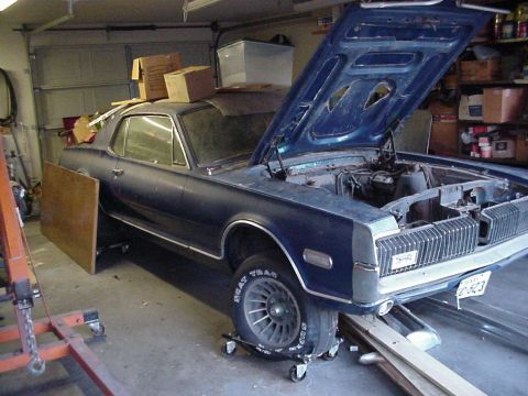 1968 Mercury Cougar - This 1968 Mercury Cougar is parked in a garage with its hood open, revealing the engine bay.