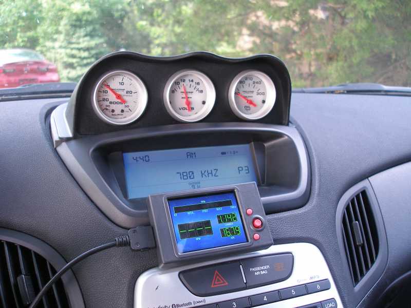 Three white-face boost, volts and oil pressure gauges in a black dash-top pod