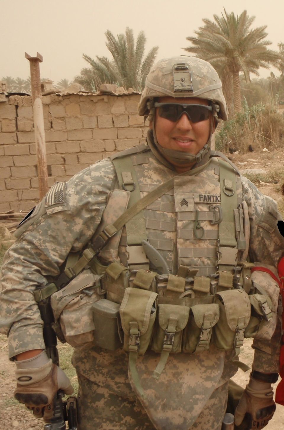 Soldier in desert camouflage uniform with helmet and tactical gear, name tag reads 'FANTAZ'