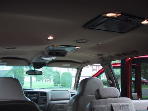 2001 Ford Excursion - The interior of a 2001 Ford Excursion is shown, the dashboard, seats, and overhead console.
