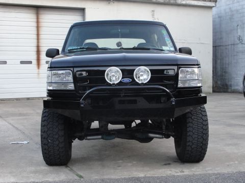 1995 Ford Bronco - Front view of a black Ford Bronco with an aftermarket bumper and off-road tires.