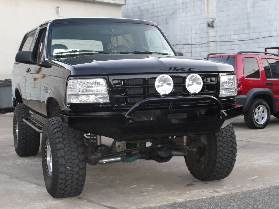 Black 1995 Ford Bronco front view with aftermarket bumper and lights