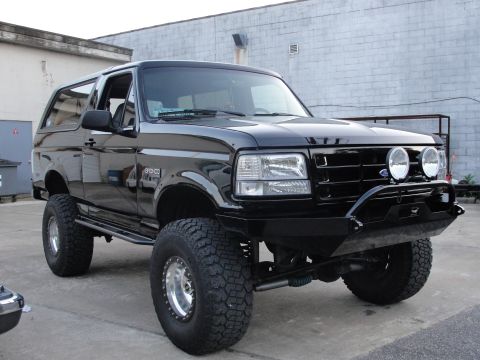 1995 Ford Bronco - This lifted 1995 Ford Bronco features a custom front bumper and auxiliary lights, giving it a appearance.
