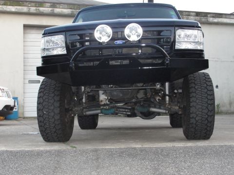 1995 Ford Bronco - This truck features a heavy-duty aftermarket bumper and auxiliary lights mounted on the grille.
