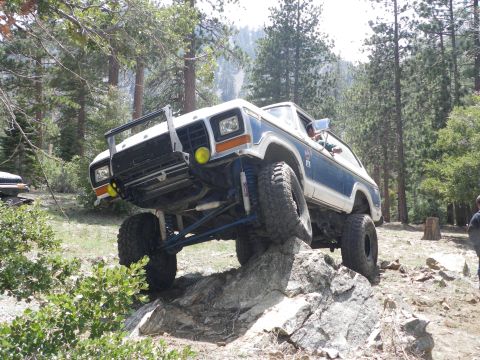 1991 Ford Bronco - This modified Ford Bronco is navigating a rocky trail, demonstrating its off-road capabilities.