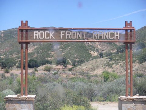 1991 Ford Bronco - Sign for Rock Front Ranch in a dry, hilly area under a clear blue sky.