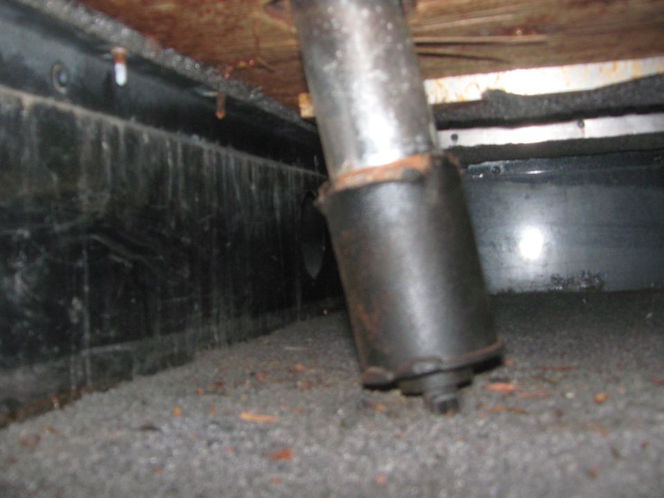 Close-up of a metal seat post mount on the floor of a vehicle