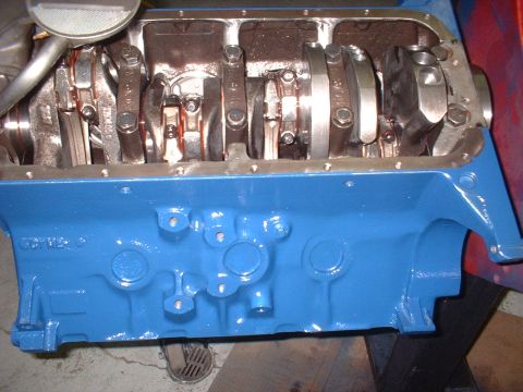 1968 Ford Mustang - Close-up of an engine block with internal components exposed, showing the crankshaft and connecting rods.