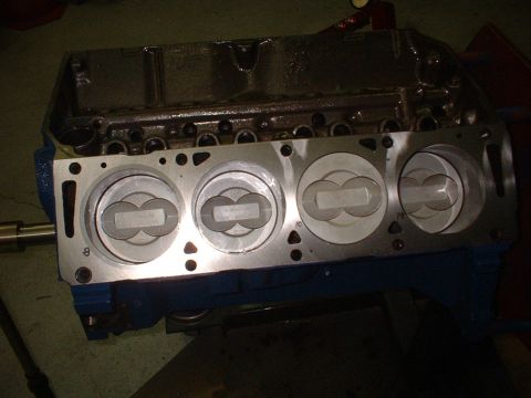 1968 Ford Mustang - Close-up view of an engine block with pistons installed, showing cylinder numbers.