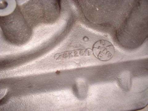 1969 Ford Torino - A close-up view of an engine casting reveals stamped identification numbers and a circular mark.