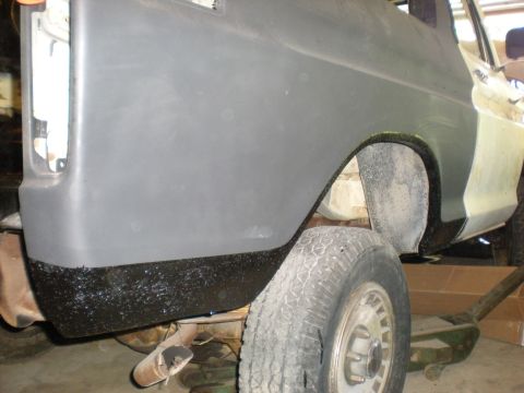 1978 Ford Bronco - The rear fender and wheel well of a 1978 Ford Bronco are visible, showing repair work in progress.