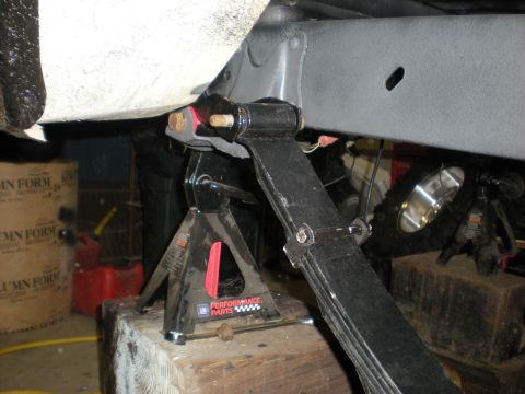 1978 Ford Bronco - Underbody view of a vehicle's suspension system being worked on, with jack stands providing support.