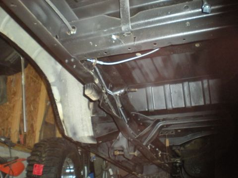1978 Ford Bronco - The underside of a 1978 Ford Bronco reveals its chassis, fuel tank, and a large tire.
