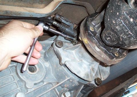 1990 Ford Bronco - Use an 11mm socket to remove the retaining nut on the tranfer case tail housing