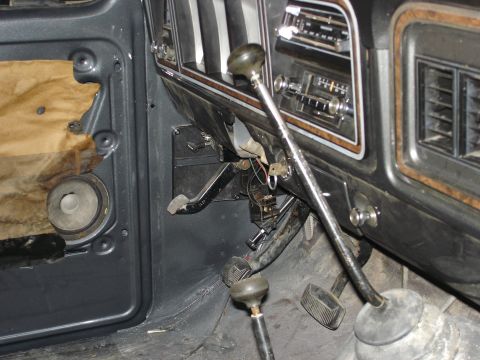 1979 Ford F-250 - The interior of a 1979 Ford F-250 reveals its dashboard, dual gear shifters, and foot pedals.