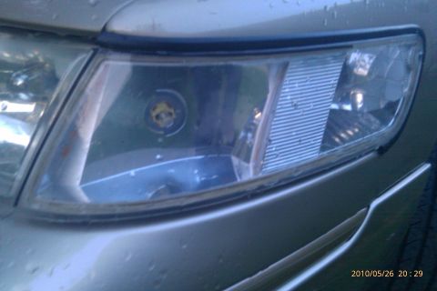 2000 Mercury Grand Marquis - Close-up of the front headlight assembly on a 2000 Mercury Grand Marquis, showing the clear corner design.