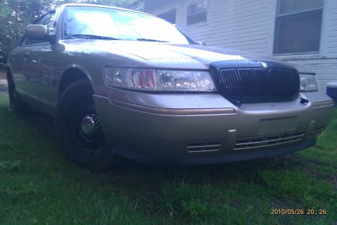 2000 Mercury Grand Marquis - A silver 2000 Mercury Grand Marquis is shown from the front-right, parked on a lawn.