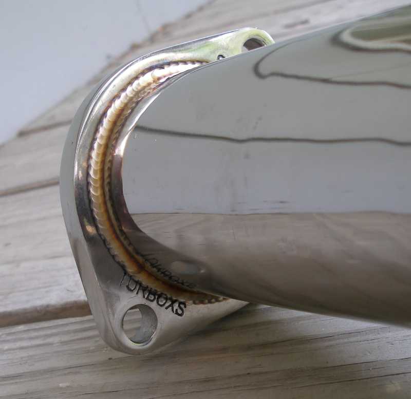 Exhaust pipe with "TUNBOXS" text and visible welds, angled view