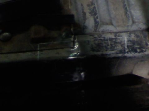 1991 Ford F-150 - Close-up of a vehicle's frame rail, showing repair work and structural details.