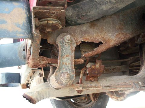 1988 Jeep YJ - Severe rust damage visible on the vehicle's frame and suspension components.