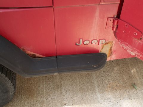 1988 Jeep YJ - Rust damage is visible on the door edge of this 1988 Jeep YJ.