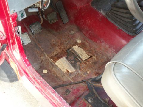 1988 Jeep YJ - The floor of this vehicle shows extensive rust damage and holes, compromising its structural integrity.