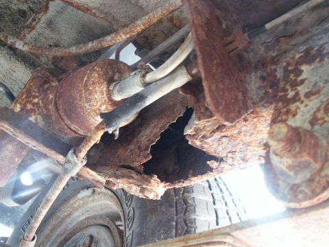 1988 Jeep YJ - Severe rust has compromised the structural integrity of the vehicle's undercarriage.