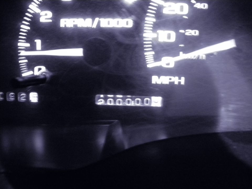 Speedometer and tachometer gauges, odometer shows 200,000 miles