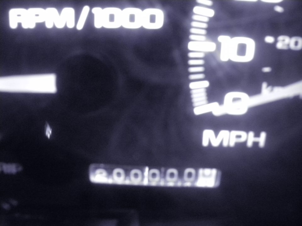 Tachometer and speedometer gauges with odometer reading 200000.0
