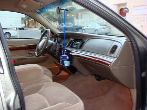 2001 Mercury Grand Marquis - The interior of a 2001 Mercury Grand Marquis features tan upholstery and wood trim accents.