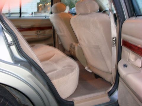 2001 Mercury Grand Marquis - Interior view of tan cloth seats and wood trim in a 2001 Mercury Grand Marquis.