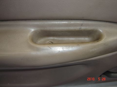 1993 Ford Bronco - Close-up of a vehicle's interior door handle, showing wear and tear.