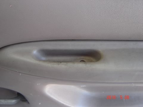 1993 Ford Bronco - Close-up of an interior door handle, showing signs of use.