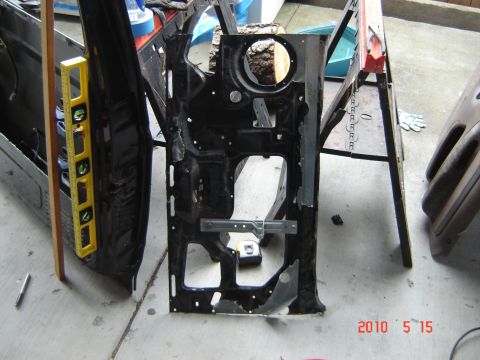 1993 Ford Bronco - The interior frame of a car door is shown, with a yellow level tool attached to the side.