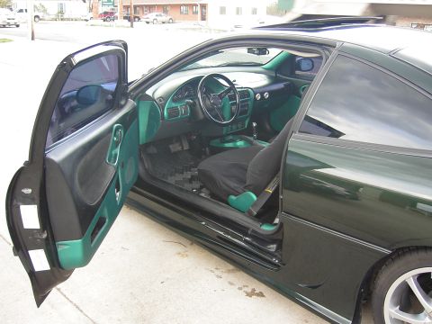 2006 Ford E350 - The interior of a coupe shows custom green paint accents on the dashboard and door panels.