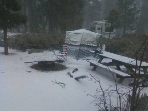 1991 Ford Bronco - Campsite scene with a tent and picnic table covered in snow, with an RV in the background.