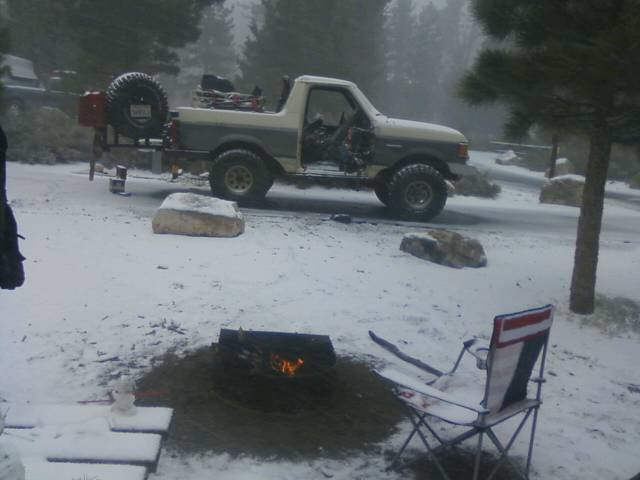1991 Ford Bronco parked in snow with spare tire on back