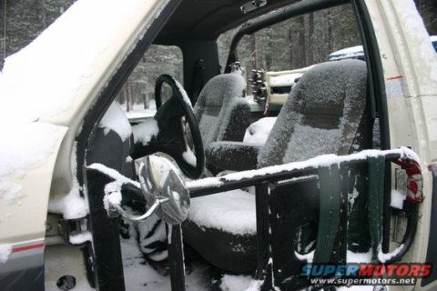 1991 Ford Bronco - Snow covers the interior of a white SUV, obscuring its model year and details.