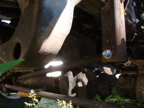 1999 Ford F-150 - Undercarriage view of heavily rusted vehicle frame and suspension components.